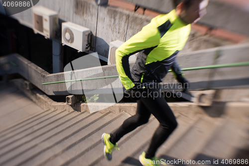 Image of man jogging on steps