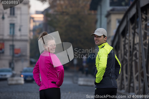 Image of couple warming up before jogging