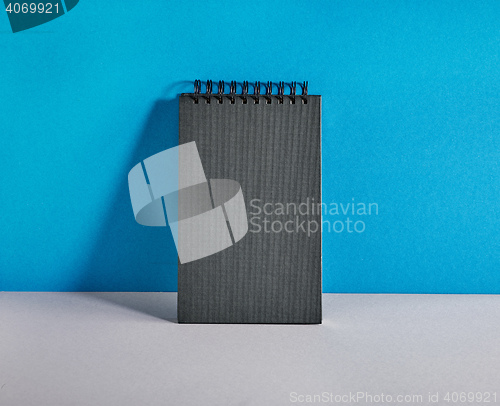 Image of black notebook on colorful background