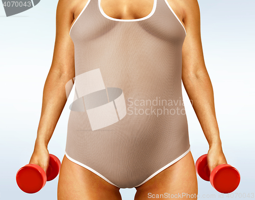 Image of fatty woman with dumbbells