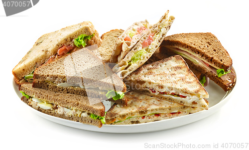 Image of plate of various triangle sandwiches