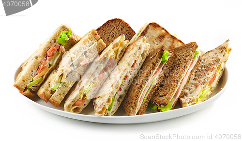 Image of plate of various triangle sandwiches