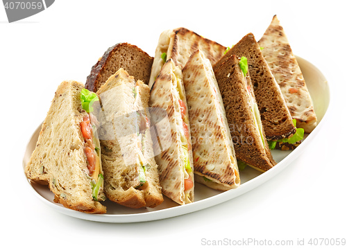 Image of plate of various triangle sandwiches