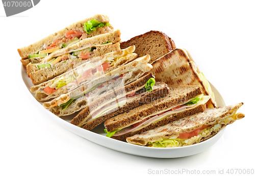 Image of plate of various triangle sandwiches