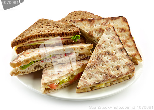 Image of plate of various triangle sandwiches