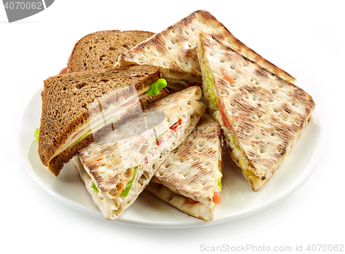 Image of plate of various triangle sandwiches