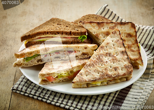 Image of plate of various triangle sandwiches