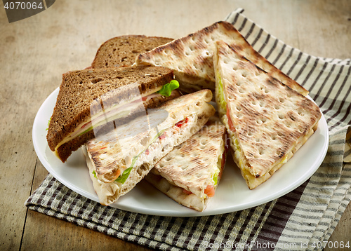 Image of plate of various triangle sandwiches