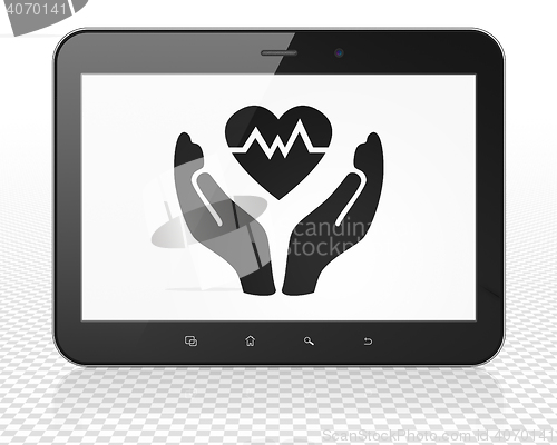 Image of Insurance concept: Tablet Pc Computer with Heart And Palm on display