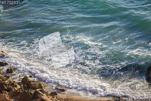 Image of Scenic view of sea waves washing big rocks