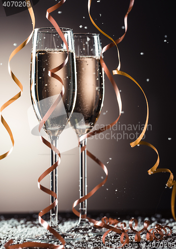 Image of Two glasses of champagne with beautiful festive ribbons and snowflakes