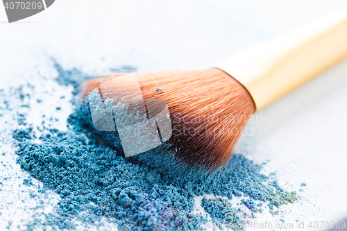 Image of Brush lie scattered on blue shadows at white background