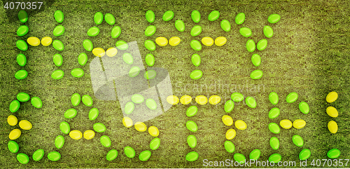 Image of Easter eggs as a \"Happy Easter\" greeting on a green grass. 3D il