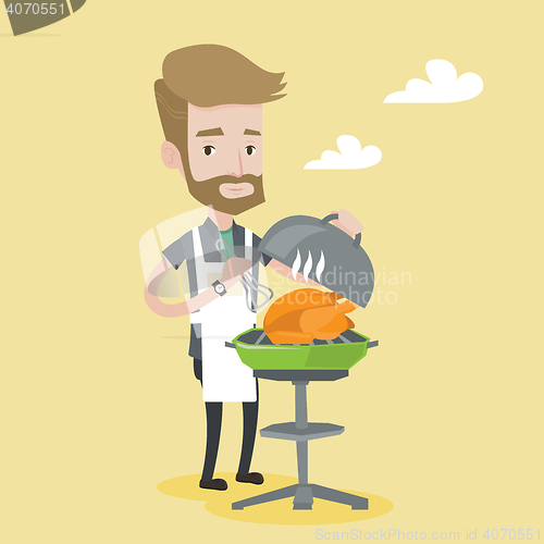 Image of Man cooking chicken on barbecue grill.