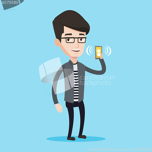 Image of Man holding ringing mobile phone.