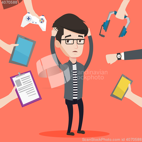 Image of Young man surrounded with his gadgets.