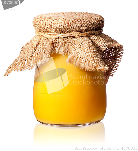 Image of Honey in a glass jar covered with burlap