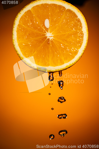 Image of Sliced orange fruit isolated on colorful blackground