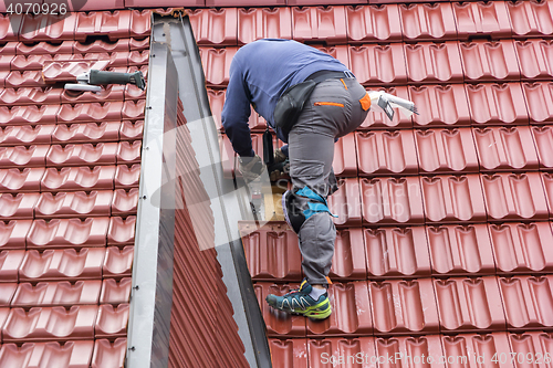 Image of Roofer repair  the roof of clay tiles