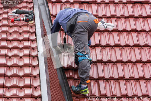 Image of Roofer repair  the roof of clay tiles