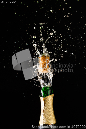 Image of Cork flies out of champagne bottle. Festive theme