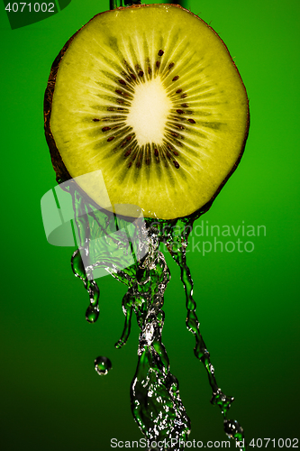 Image of Ripe kiwifruit with water splash close up