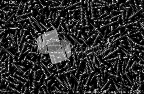 Image of Background pile of shiny black screws