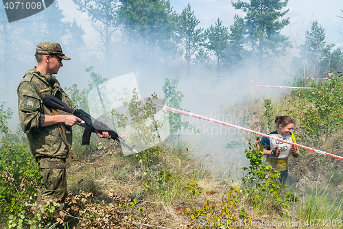 Image of Athletes run on a ravine in extrim race. Tyumen