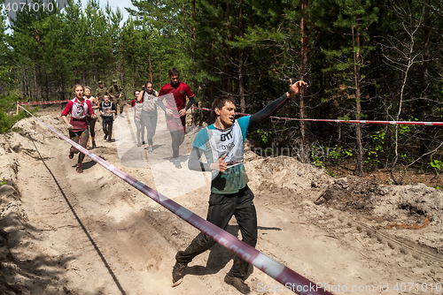 Image of Sportsmen run between stages in extrim race.Tyumen