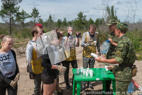 Image of Athletes drink water on route.Tyumen