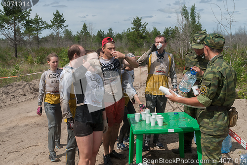 Image of Athletes drink water on route.Tyumen