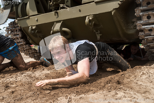 Image of Racers move under tank in extrim race. Tyumen