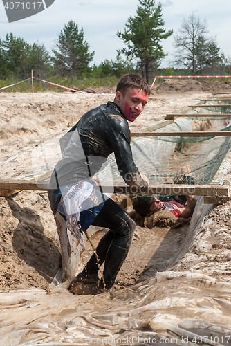 Image of Men creep on an entrenchment with sand and water