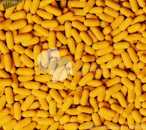 Image of Macro closeup of orange Tic Tacs scattered