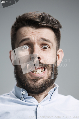 Image of Portrait of young man with shocked facial expression