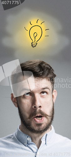 Image of Man is looking reminiscing. Over gray background