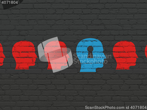 Image of Learning concept: head with keyhole icon on wall background