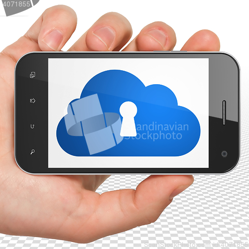 Image of Cloud networking concept: Hand Holding Smartphone with Cloud With Keyhole on display