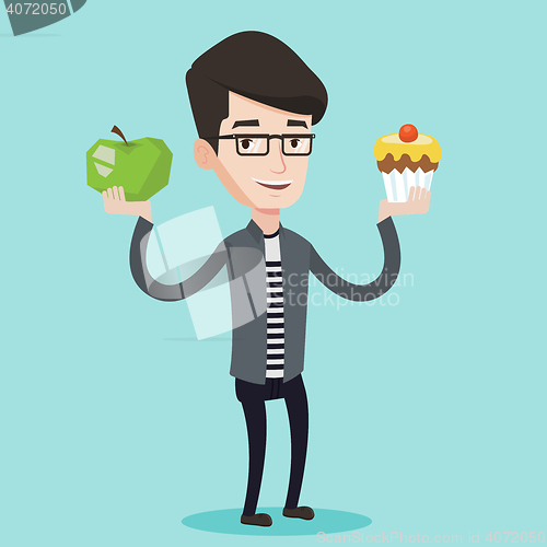 Image of Man choosing between apple and cupcake.