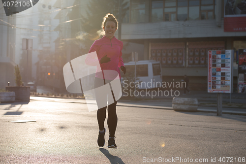 Image of sporty woman jogging on morning