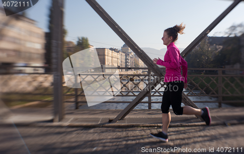 Image of sporty woman jogging on morning