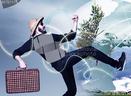 Image of man wtih suitcase ready to travel as tourist on gray background