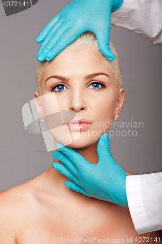 Image of Cosmetic plastic surgeon touching aesthetics face