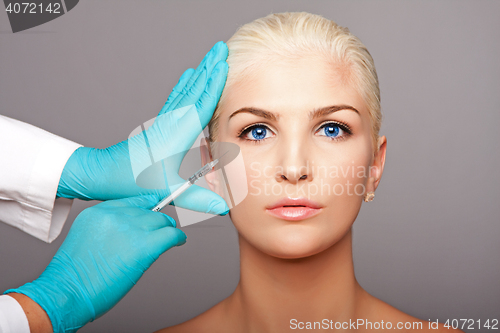 Image of Cosmetic plastic surgeon injecting aesthetics face