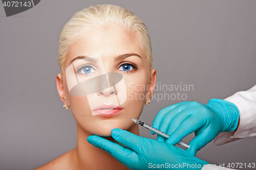 Image of Cosmetic plastic surgeon injecting aesthetics face