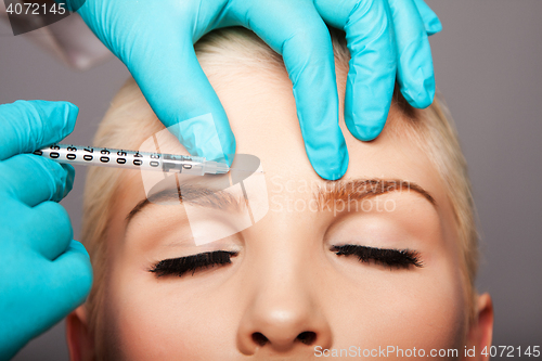 Image of Cosmetic plastic surgeon injecting aesthetics face