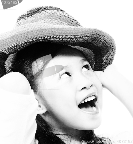 Image of Smiling And Happy Girl Putting On A Hat