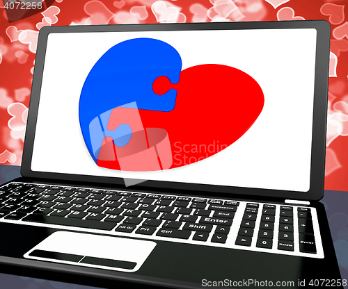 Image of Puzzle Heart On Laptop Shows Engagement