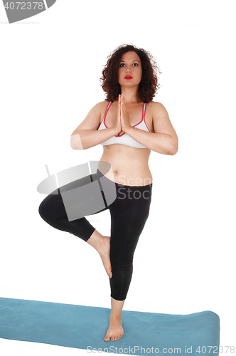 Image of Yoga woman standing on floor.