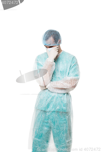 Image of Surgeon portrait. covered face with his hands. sad. isolated on white background